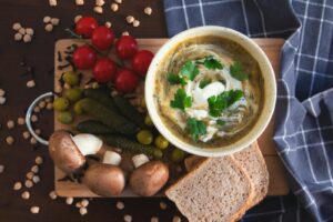 Delicious creamy vegetable soup with fresh ingredients and bread. Perfect for food lovers.